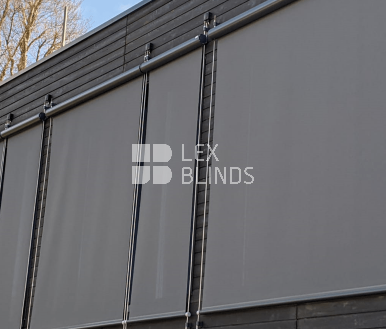 Outdoor roller blinds with steel side cables